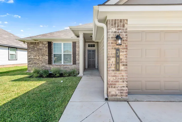 a view of front door of house and yard