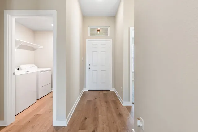 a view of a hallway with wooden floor
