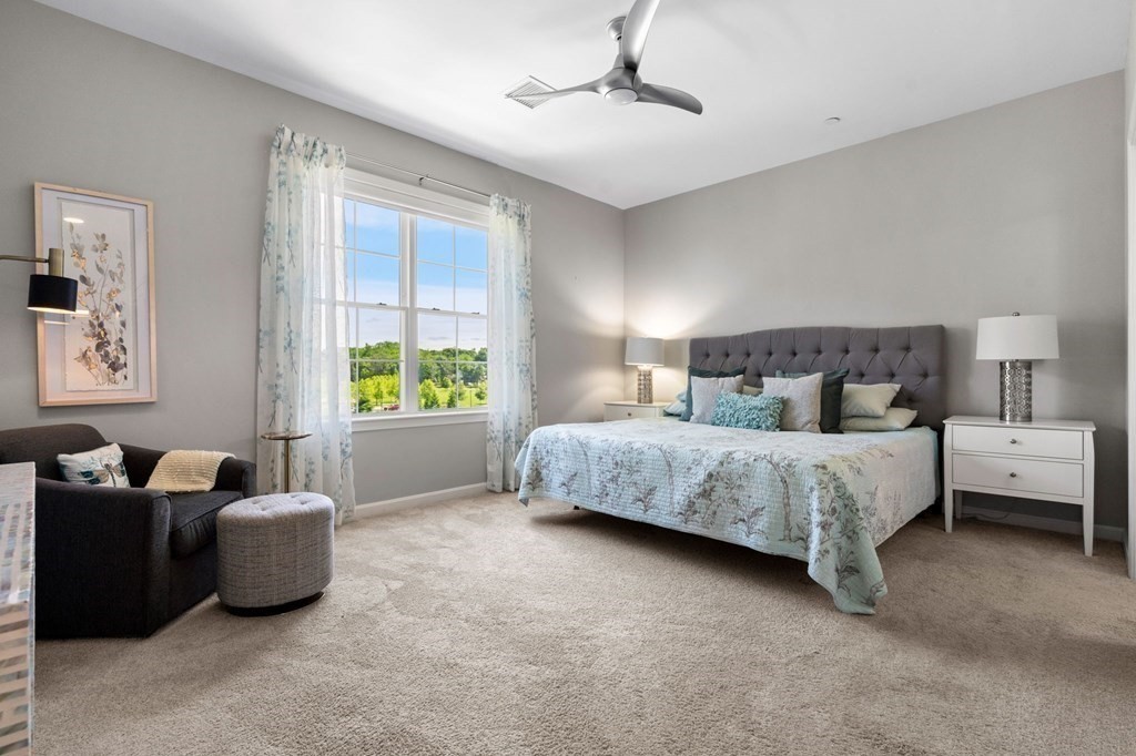 1 Revolution Way, Unit 201 Canton, MA 02021 - Photo 13 of 38 a bedroom with a bed and a couch