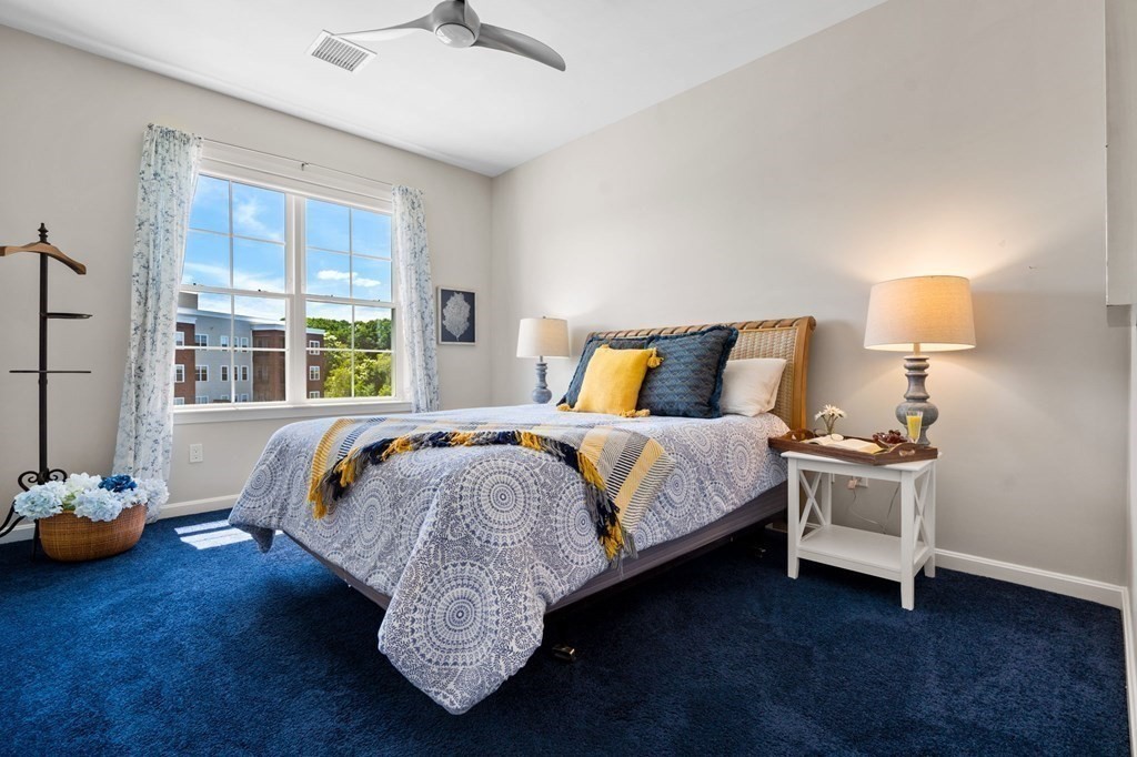 1 Revolution Way, Unit 201 Canton, MA 02021 - Photo 17 of 38 a bed sitting in a bedroom next to a window