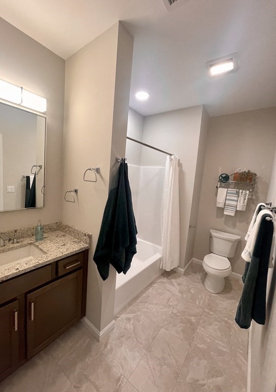 1 Revolution Way, Unit 201 Canton, MA 02021 - Photo 20 of 38 a bathroom with a granite countertop sink a toilet a vanity and mirror