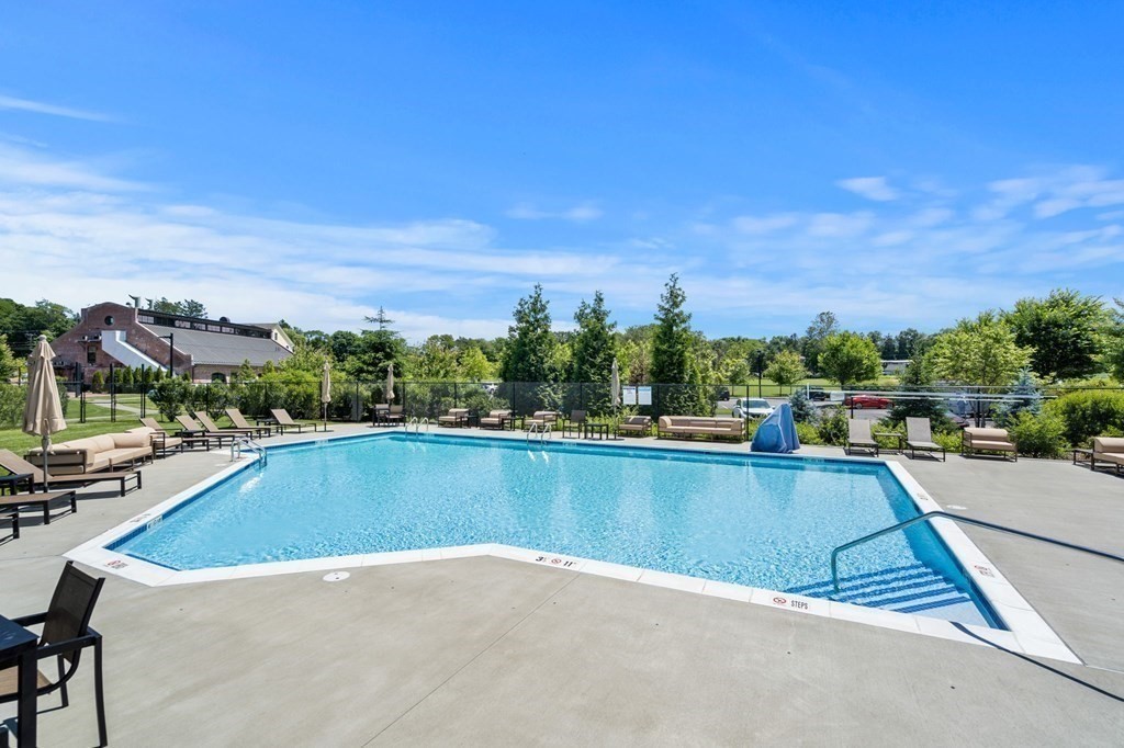 1 Revolution Way, Unit 201 Canton, MA 02021 - Photo 30 of 38 a view of a swimming pool and trees in the background