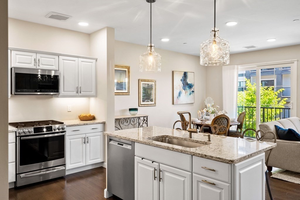 1 Revolution Way, Unit 201 Canton, MA 02021 - Photo 7 of 38 a kitchen with a sink stove and microwave