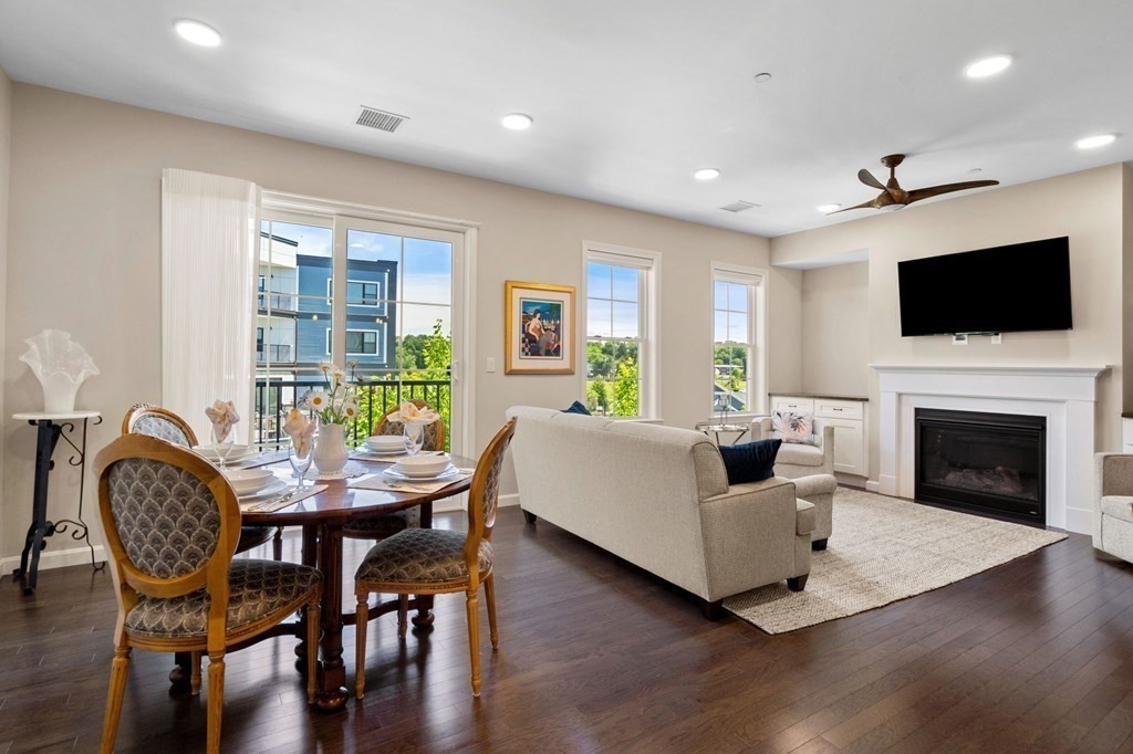1 Revolution Way, Unit 201 Canton, MA 02021 - Photo 10 of 38 a living room with furniture a flat screen tv and a fireplace
