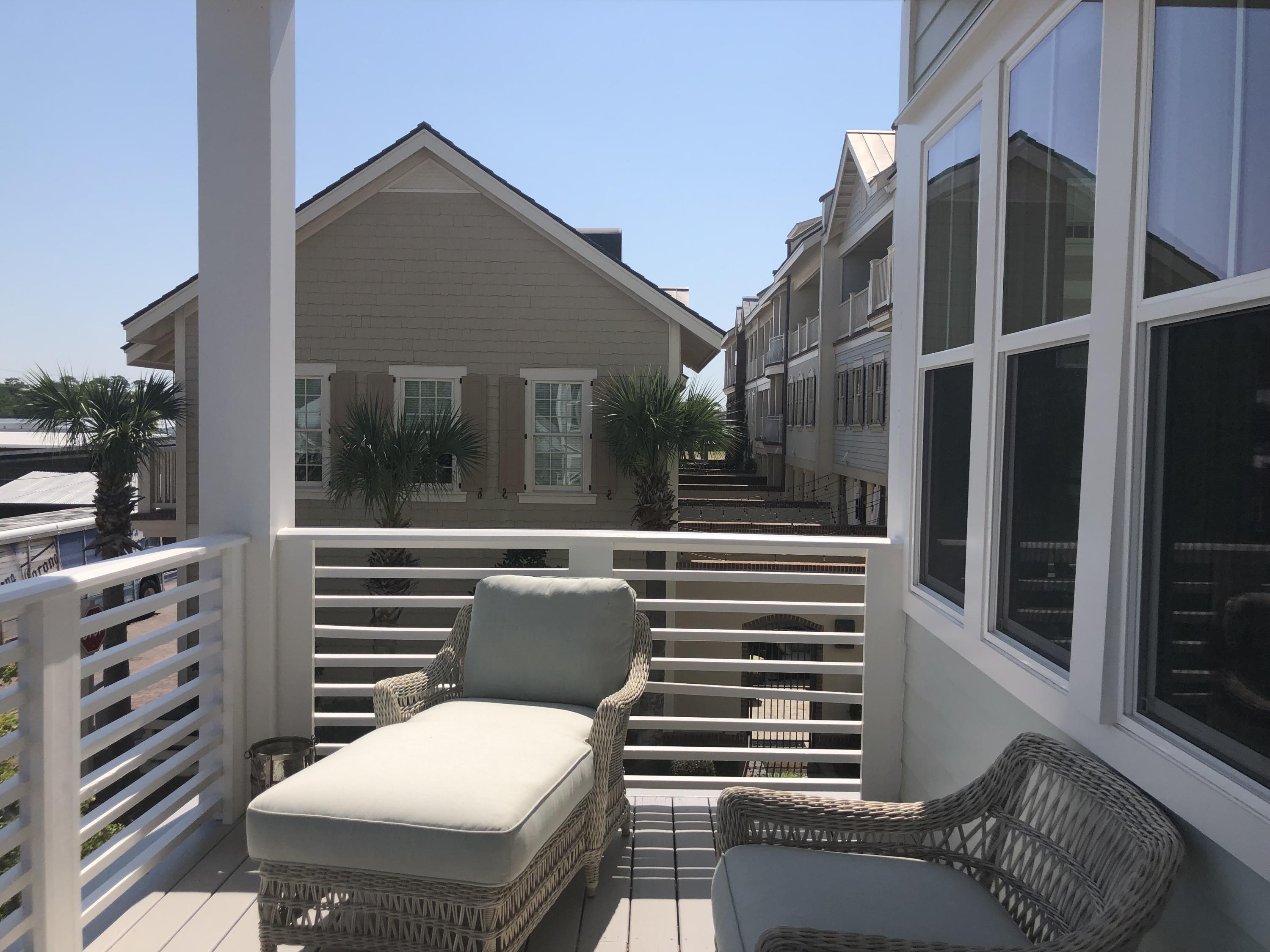 59 East Crabbing Hole Ln Inlet Beach Inlet Beach, FL 32461 - Photo 6 of 62 a view of a patio with couches chairs and potted plants