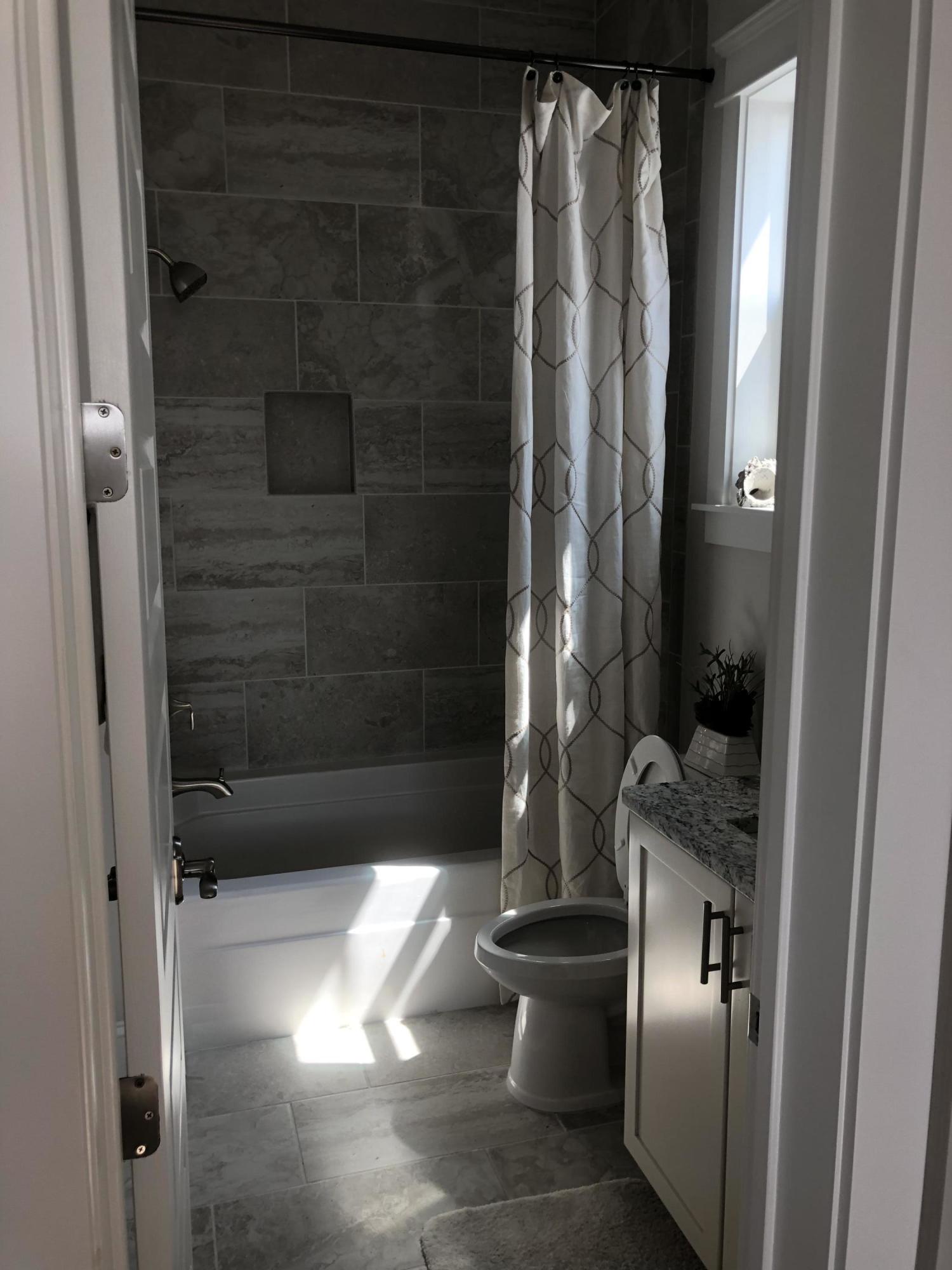 59 East Crabbing Hole Ln Inlet Beach Inlet Beach, FL 32461 - Photo 56 of 62 a bathroom with a glass shower door