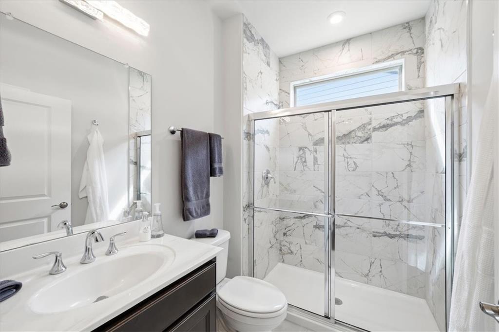 2457 Naples Street Hoschton, GA 30548 - Photo 23 of 41 a bathroom with a sink toilet and shower