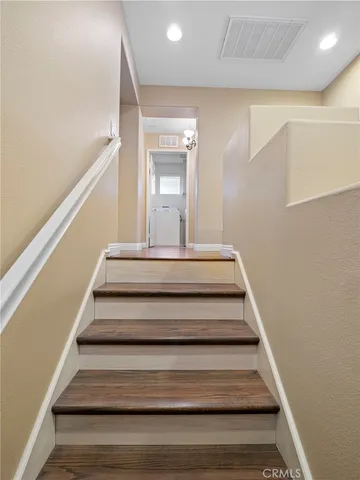 a view of staircase with white walls and a window