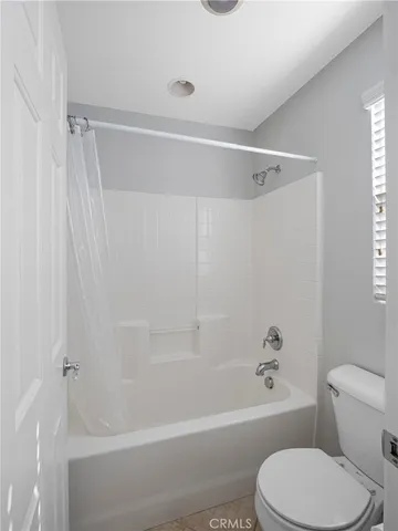 a bathroom with a toilet and a bathtub