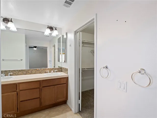 a spacious bathroom with a double vanity sink mirror and double