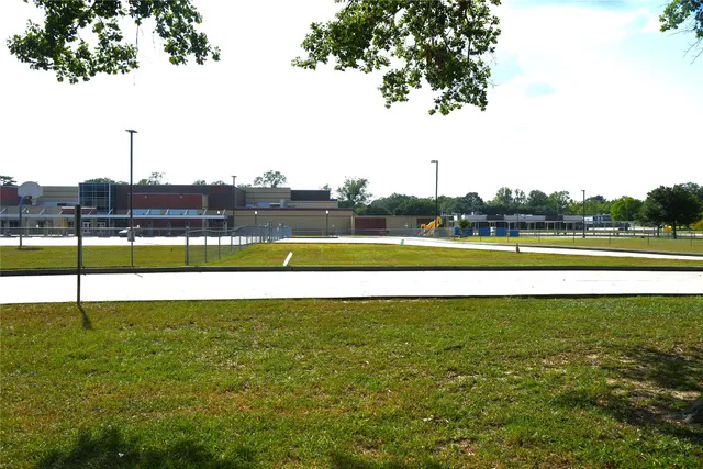 a view of a swimming pool and a yard