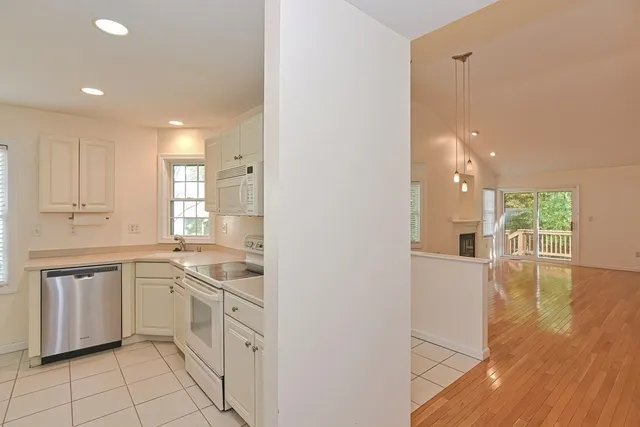 a kitchen with white cabinets and sink