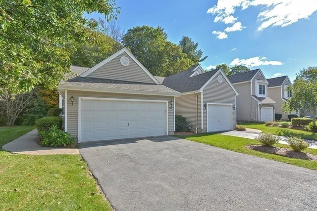 a view of a house with a yard and garage