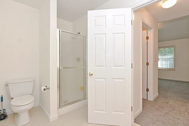 a bathroom with a toilet and a shower