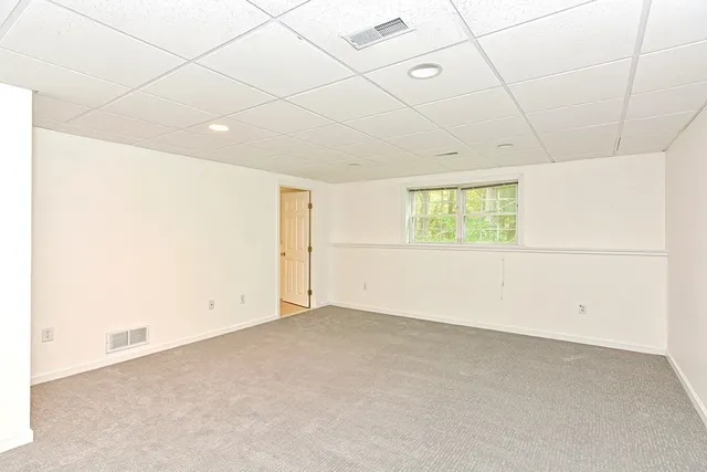 an empty room with a empty space and windows