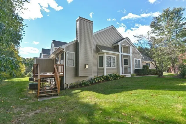 a backyard of a house with table and chairs