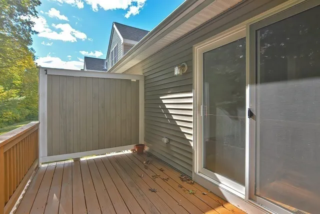 a view of a backyard with wooden floor and floor to ceiling window