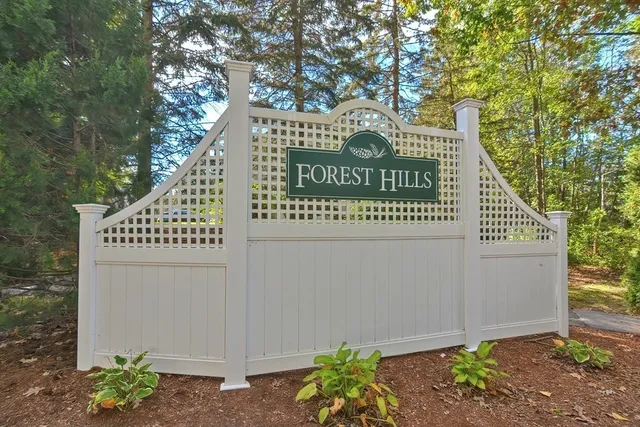 a view of a sign under a tree