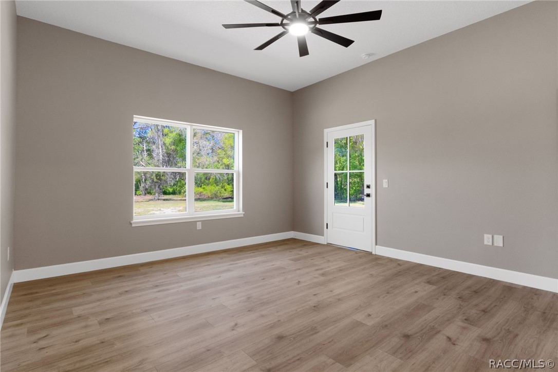 4530 South Florida Avenue Inverness, FL 34450 - Photo 17 of 100 wooden floor in an empty room with a window