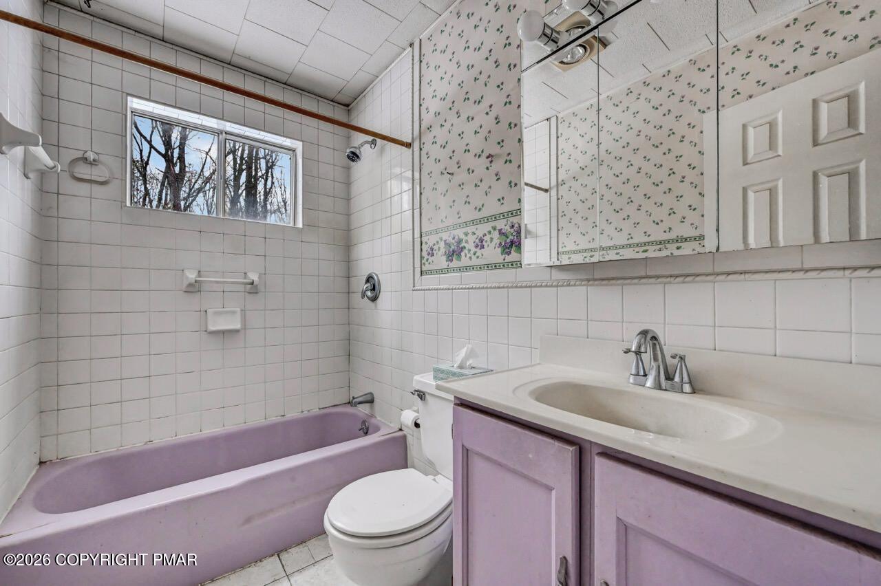 1912 Johns Road Effort, PA 18330 - Photo 29 of 44 a bathroom with a sink a toilet a mirror a bathtub and shower