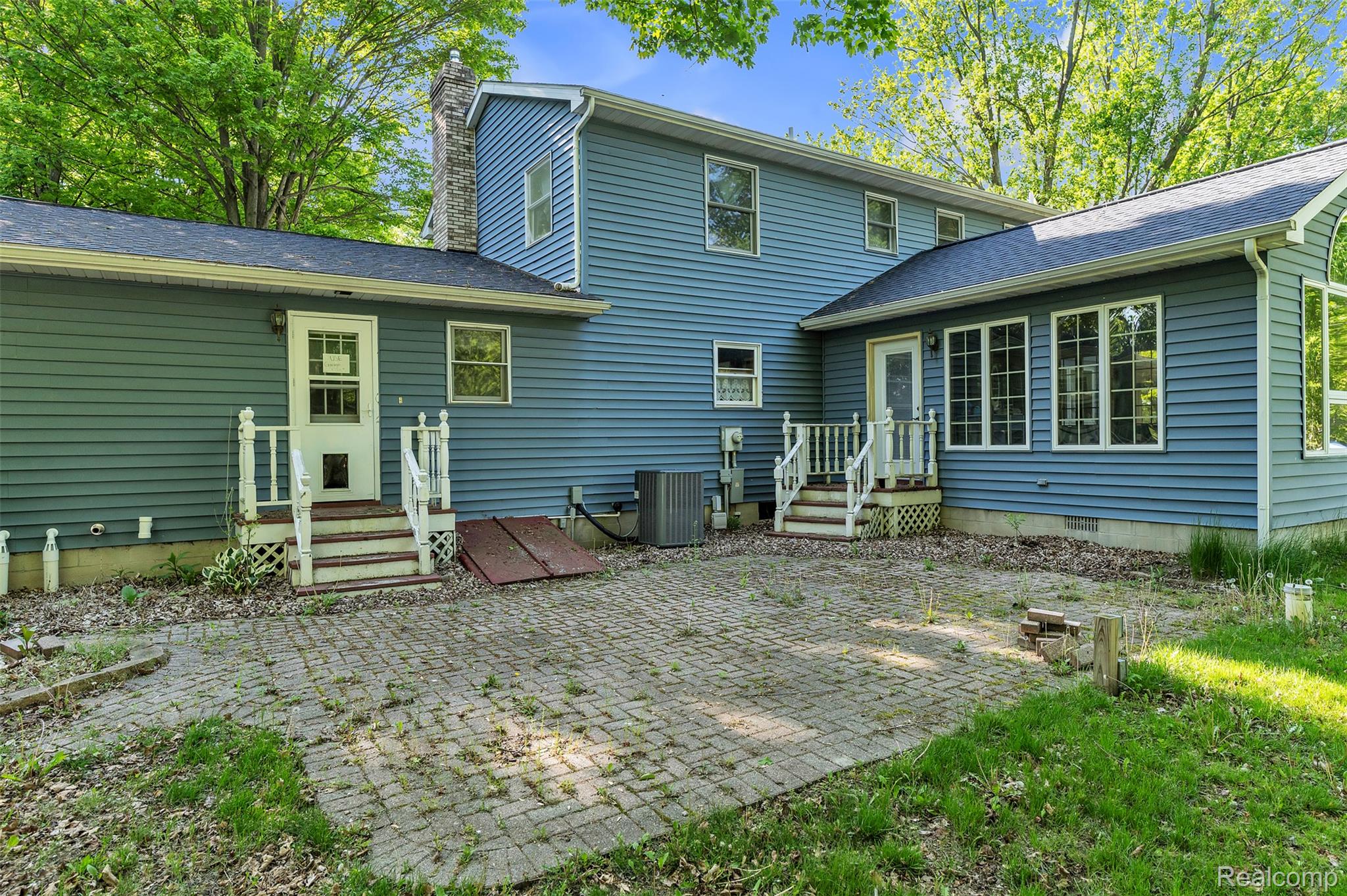 1345 Ives Road Mason, MI 48854 - Photo 61 of 92 Back of house with a patio, a chimney, and a shingled roof