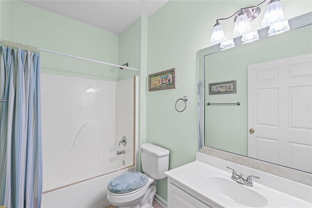 460 Tribble Gap Road, Unit 102 Cumming, GA 30040 - Photo 15 of 21 a bathroom with a sink a toilet and shower
