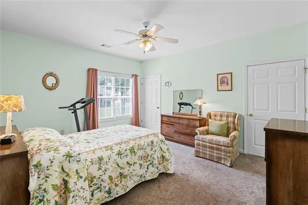 a bedroom with a bed and a couch