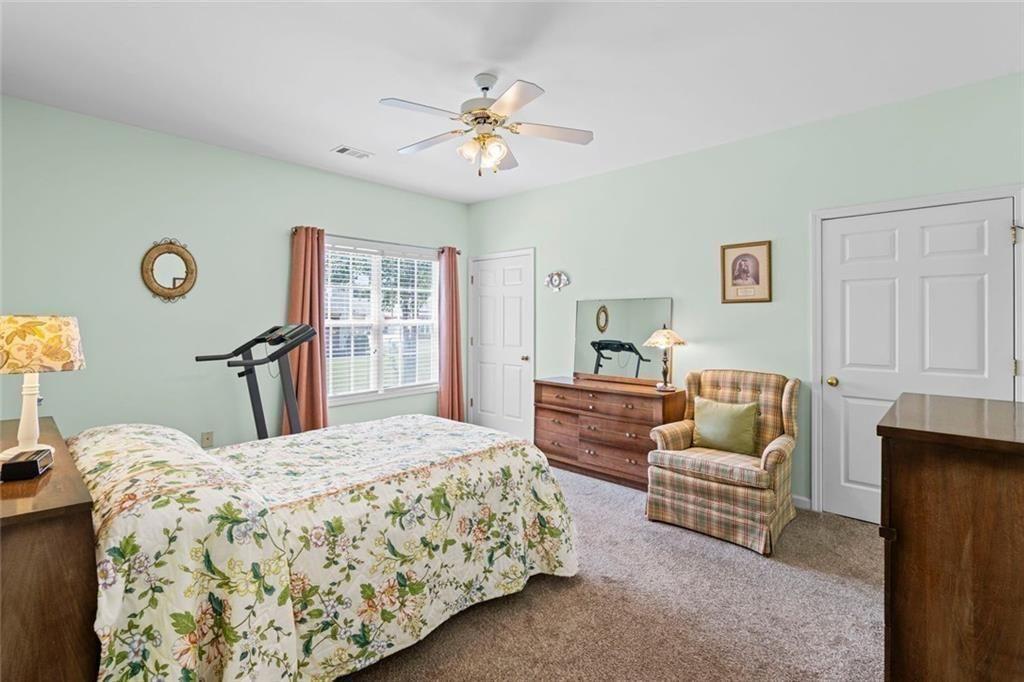 460 Tribble Gap Road, Unit 102 Cumming, GA 30040 - Photo 17 of 21 a bedroom with a bed and a couch