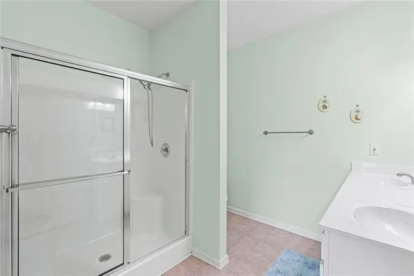 a bathroom with a shower and a sink
