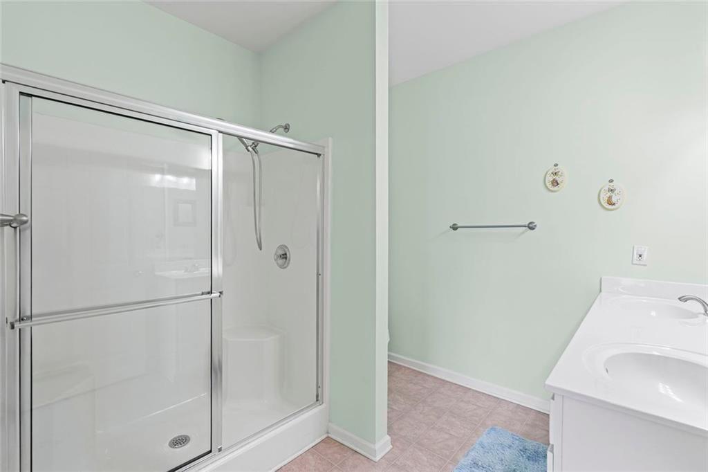 460 Tribble Gap Road, Unit 102 Cumming, GA 30040 - Photo 19 of 21 a bathroom with a shower and a sink