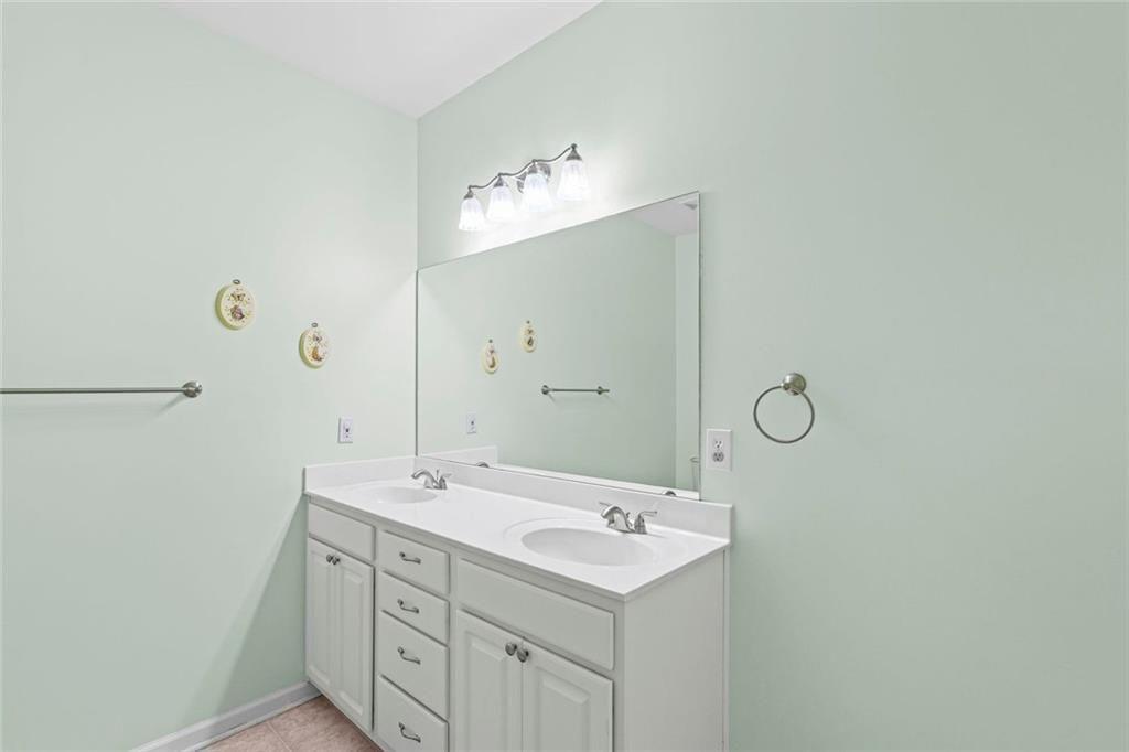 460 Tribble Gap Road, Unit 102 Cumming, GA 30040 - Photo 20 of 21 a bathroom with a sink and a mirror