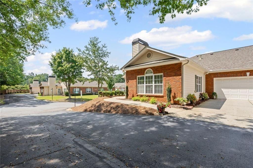 460 Tribble Gap Road, Unit 102 Cumming, GA 30040 - Photo 2 of 21 a view of a house with backyard and a tree