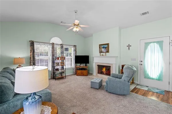 a living room with furniture and a fireplace