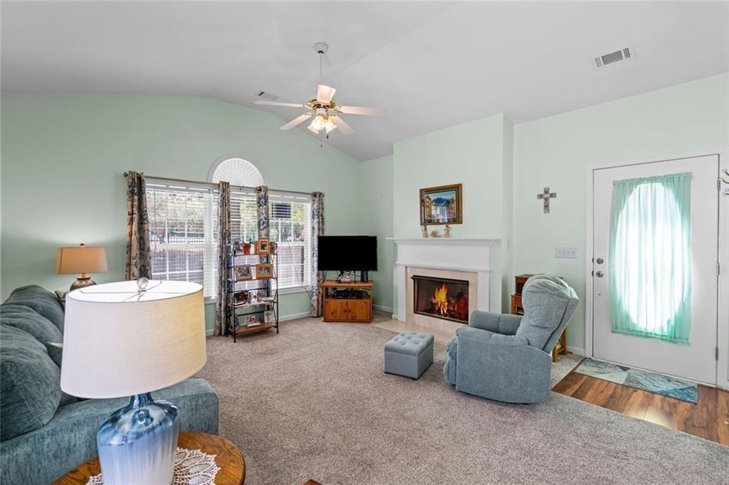 460 Tribble Gap Road, Unit 102 Cumming, GA 30040 - Photo 6 of 21 a living room with furniture and a fireplace