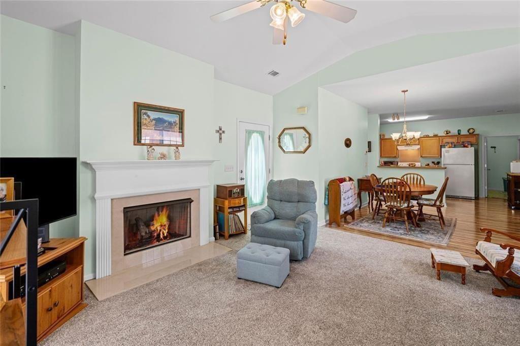 460 Tribble Gap Road, Unit 102 Cumming, GA 30040 - Photo 7 of 21 a living room with furniture and a fireplace
