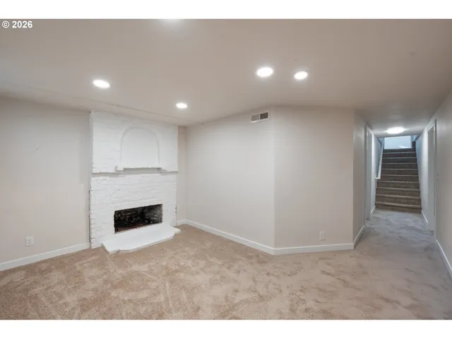 a view of empty room with a fireplace