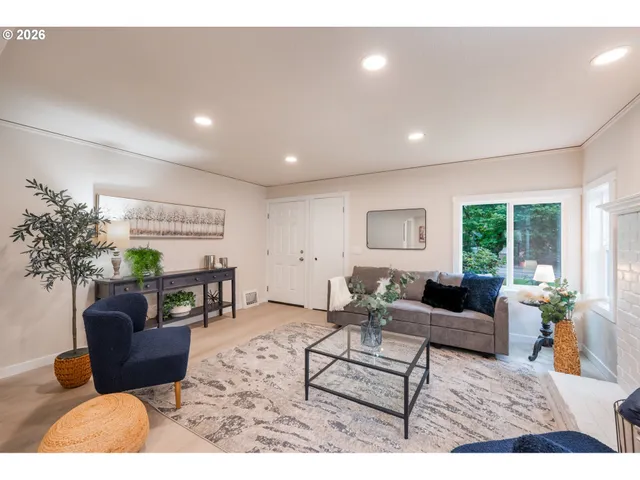 a living room with furniture potted plant and a window