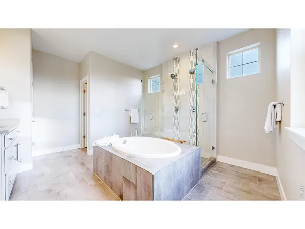 a bathroom with a sink a toilet a mirror and shower