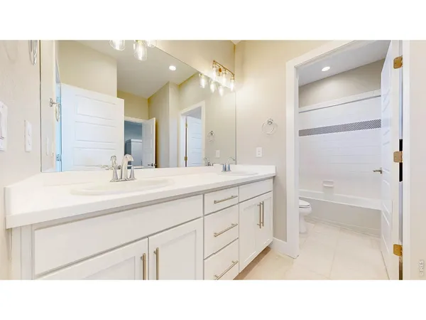 a bathroom with a sink double vanity and a mirror
