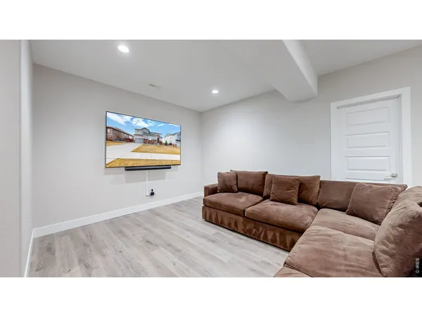 a living room with furniture and a wall painting