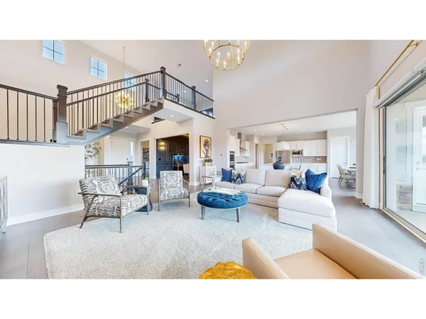 a living room with furniture and a chandelier