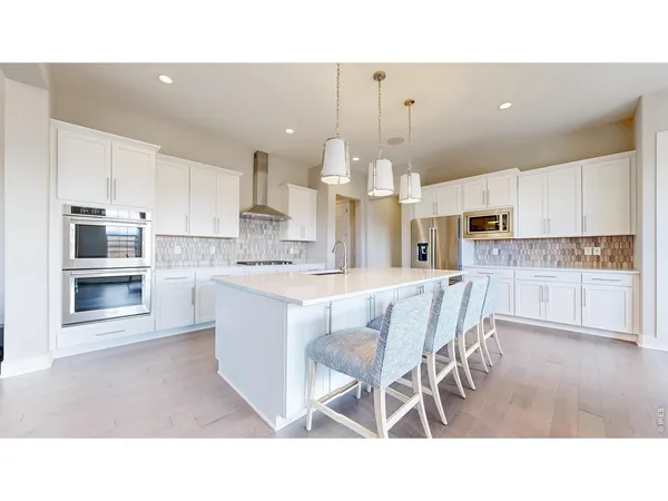 a open kitchen with stainless steel appliances kitchen island granite countertop a sink and cabinets