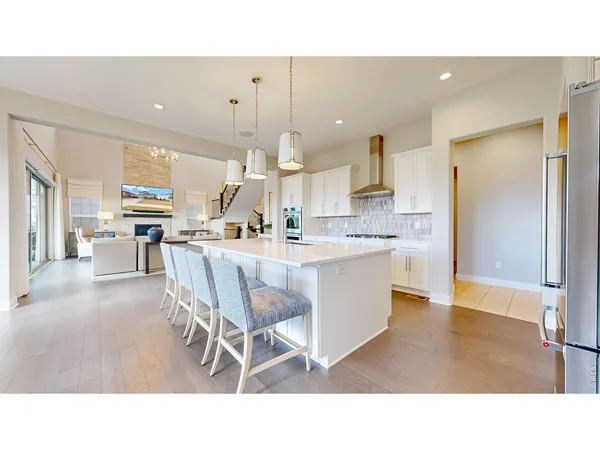 a kitchen with a table chairs refrigerator and cabinets