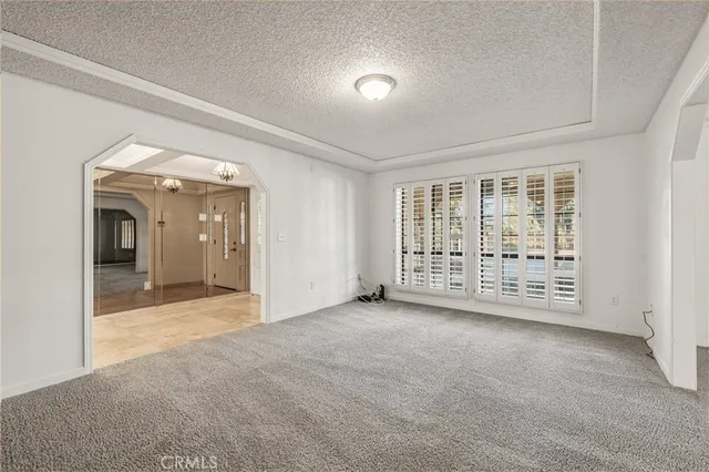 a large kitchen with kitchen island a large counter top space stainless steel appliances and cabinets