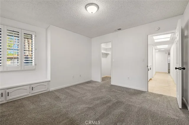 a view of a house with a yard and mountain view in back