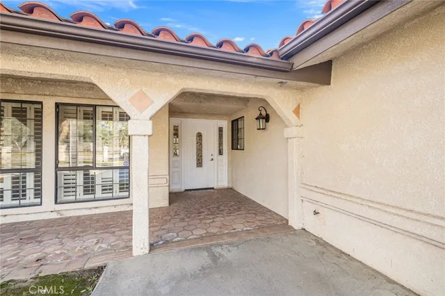 a view of an empty room with a fireplace and a window