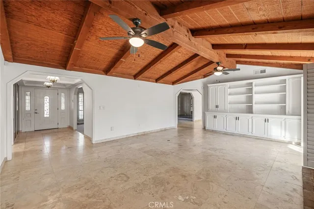 a view of empty room with fireplace and windows