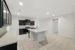 a kitchen with stainless steel appliances a sink stove and cabinets