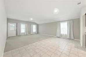 a view of an empty room with windows