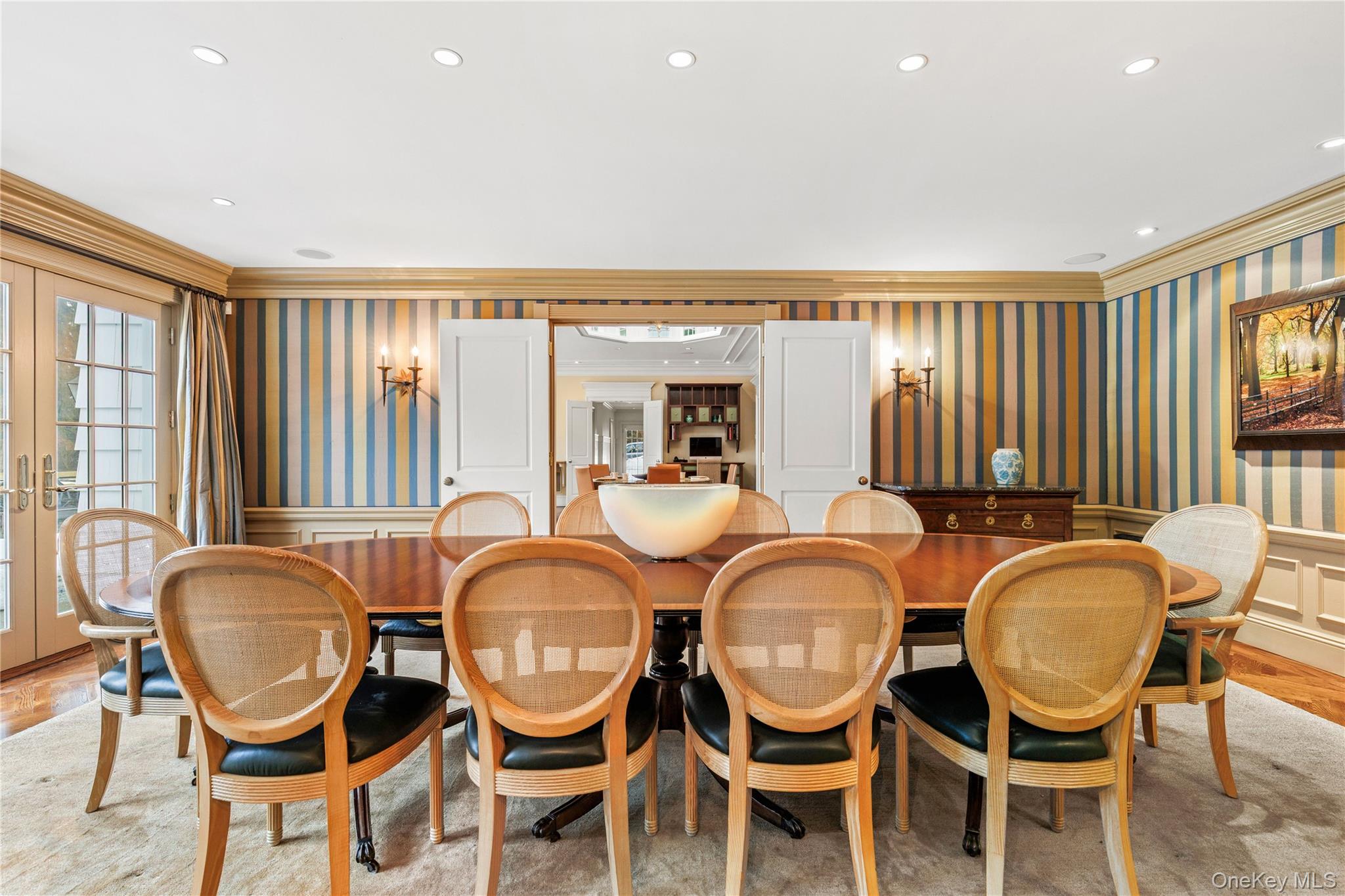 25 Stratford Road Harrison, NY 10528 - Photo 16 of 47 a dining room with chandelier glass windows and chairs